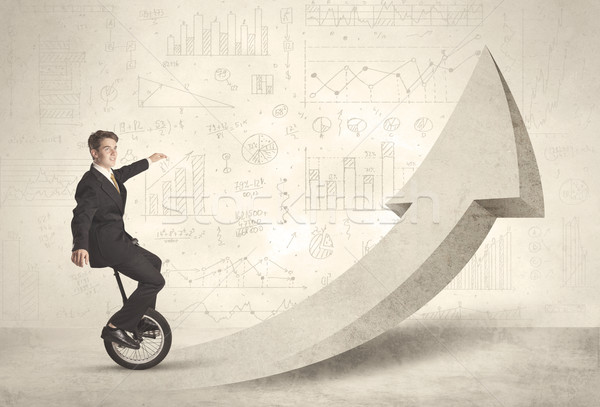 Happy business man riding a monocycle up on an arrow  Stock photo © ra2studio