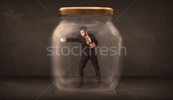 Businessman shut into a glass jar concept Stock photo © ra2studio
