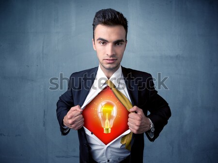 Businessman ripping off shirt and idea light bulb appears  Stock photo © ra2studio