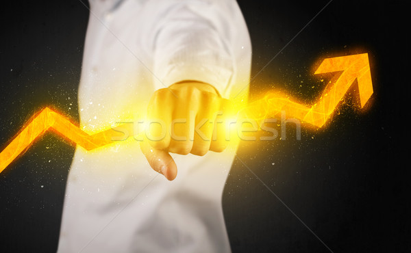 Business person holding a hot glowing upright arrow Stock photo © ra2studio