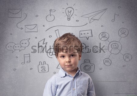 Smart kid in front of a drawn up grey wall Stock photo © ra2studio