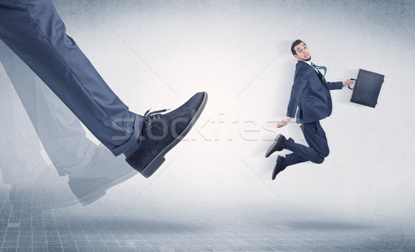 Businessman foot kicking small businessman Stock photo © ra2studio