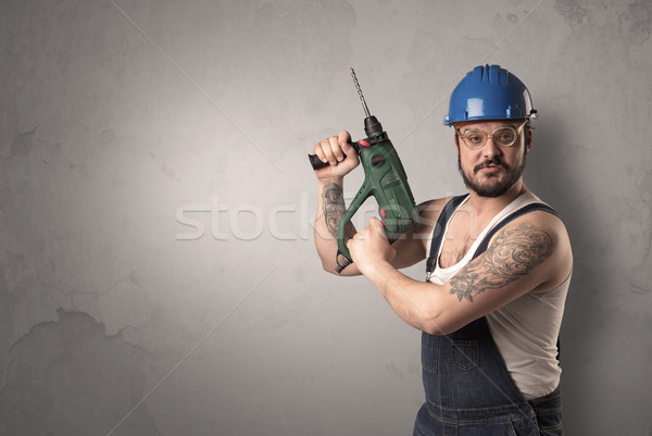Craftsman standing in front of an empty wall. Stock photo © ra2studio