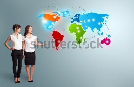 young women presenting colorful world map Stock photo © ra2studio