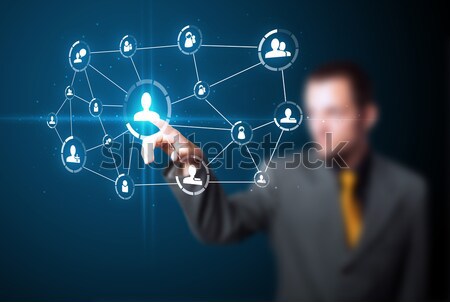 Businessman pressing modern social type of icons Stock photo © ra2studio