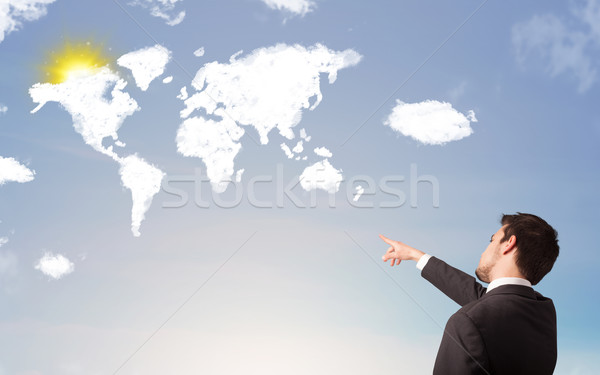 Businessman looking at world clouds and sun on blue sky Stock photo © ra2studio