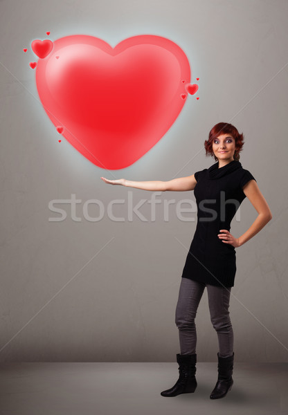 Young lady holding lovely 3d red heart Stock photo © ra2studio