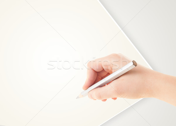 Stock photo: Human hand drawing with pencil on empty paper template