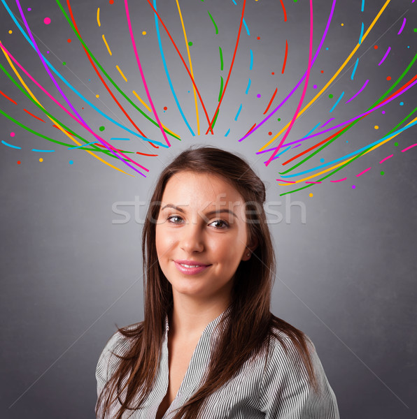 Young girl thinking with colorful abstract lines overhead Stock photo © ra2studio