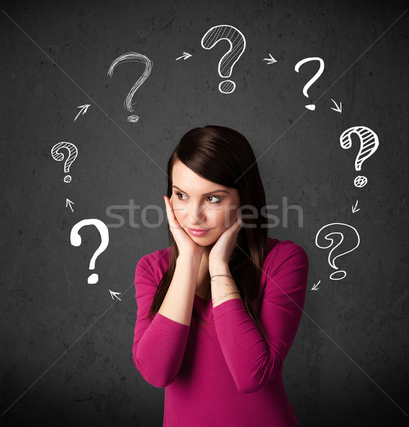 Young woman thinking with question mark circulation around her h Stock photo © ra2studio