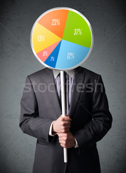 Businessman holding a pie chart Stock photo © ra2studio