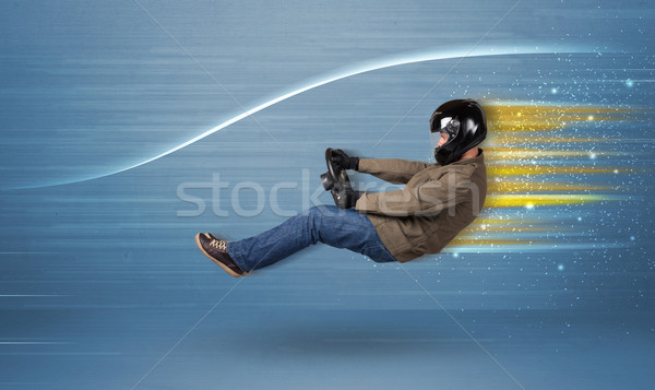 Young man driving in imaginary fast car with blurred lines  Stock photo © ra2studio