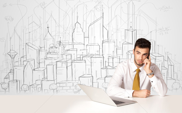 Businessman sitting at the white table with hand drawn buildings Stock photo © ra2studio