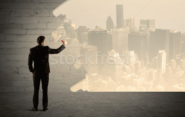 Salesman painting city scape on wall Stock photo © ra2studio
