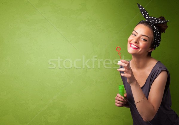 Beautiful woman blowing soap bubble on copyspace background Stock photo © ra2studio