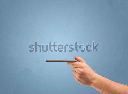 Hand with remote control Stock photo © ra2studio