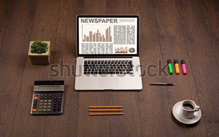 Computer desk with laptop and red arrow chart in screen Stock photo © ra2studio