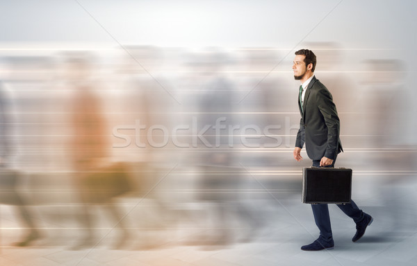 Businessman walking on a crowded street Stock photo © ra2studio