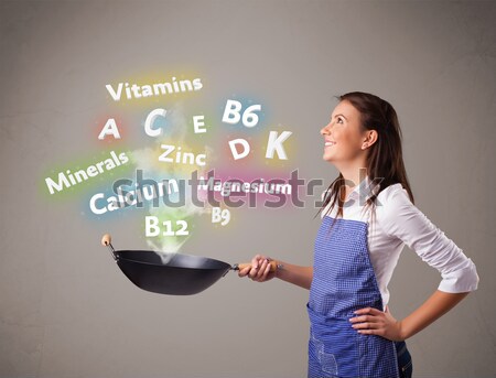 Young woman cooking vitamins and minerals Stock photo © ra2studio