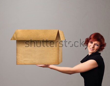 Young woman holding an empty cardboard box Stock photo © ra2studio