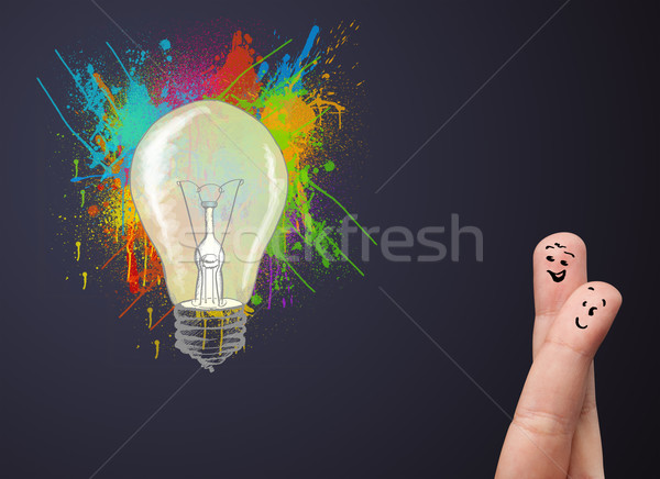 Happy cheerful smiley fingers looking at abstract hand drawn colorful lightbulb Stock photo © ra2studio