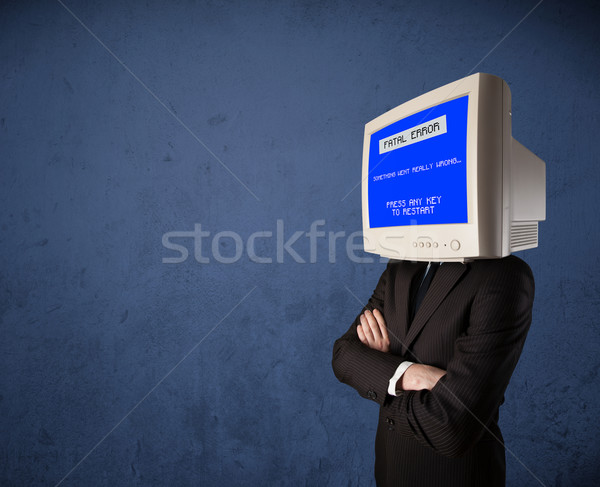 Stock photo: Person with a monitor head and fatal error blue screen on the di