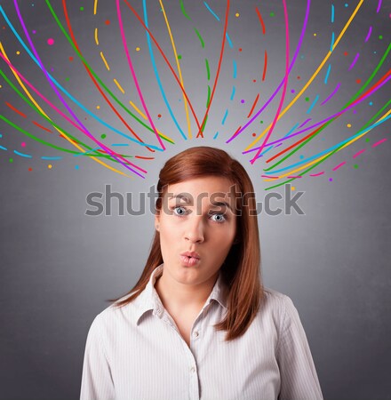 Young girl thinking with colorful abstract lines overhead Stock photo © ra2studio