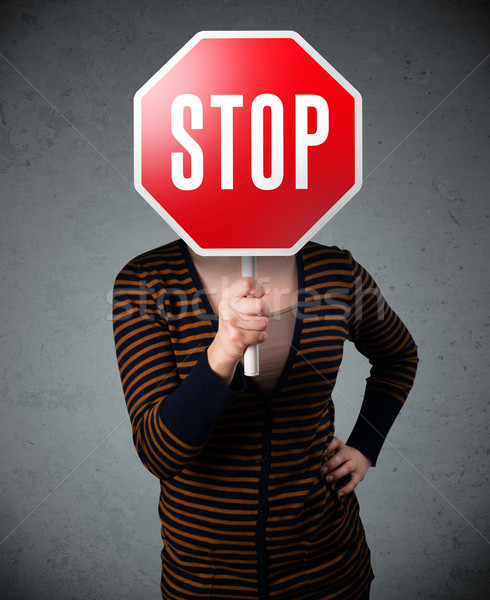 Young woman holding a stop sign Stock photo © ra2studio