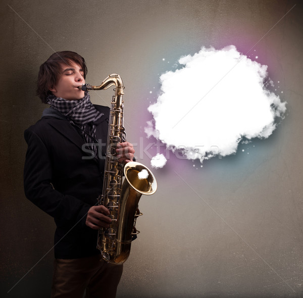 Young man playing on saxophone with copy space in white cloud Stock photo © ra2studio