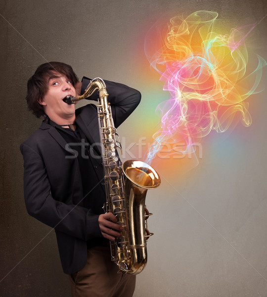 Attractive musician playing on saxophone with colorful abstract  Stock photo © ra2studio