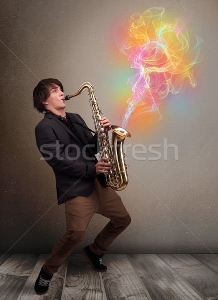 Atractivo músico jugando saxófono colorido resumen Foto stock © ra2studio