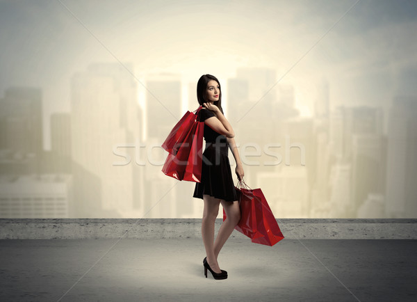 City woman standing with shopping bags Stock photo © ra2studio