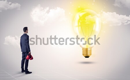 Businesswoman on rock mountain with idea bulb Stock photo © ra2studio