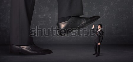 Stock photo: Huge leg stepping on a tiny businnesswoman concept