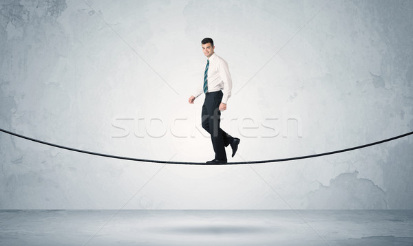 Sprzedaży facet równoważenie mocno liny biznesmen Zdjęcia stock © ra2studio