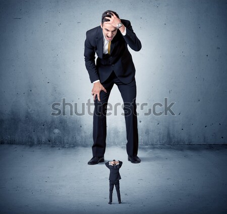 Huge business guy looking at small coworker Stock photo © ra2studio