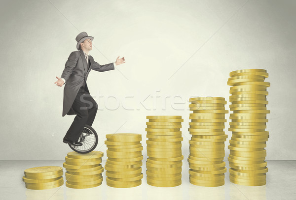 Business man riding monocycle up on coin graph Stock photo © ra2studio