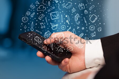 Hand halten Smartphone Hand gezeichnet Medien Symbole Stock foto © ra2studio