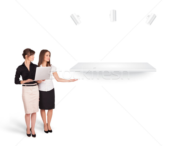 Beutiful young women presenting modern copy space Stock photo © ra2studio