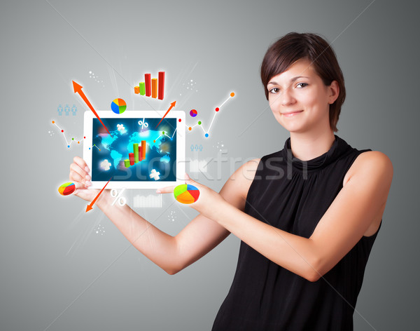 woman holding modern tablet with colorful diagrams and graphs Stock photo © ra2studio