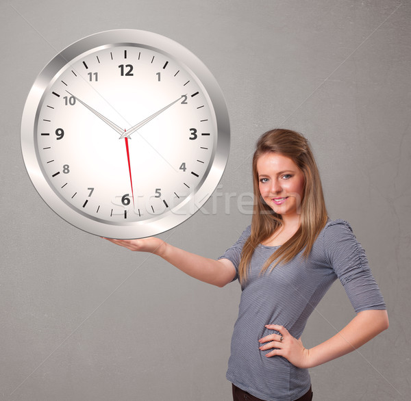 Attractive lady holding a huge clock Stock photo © ra2studio