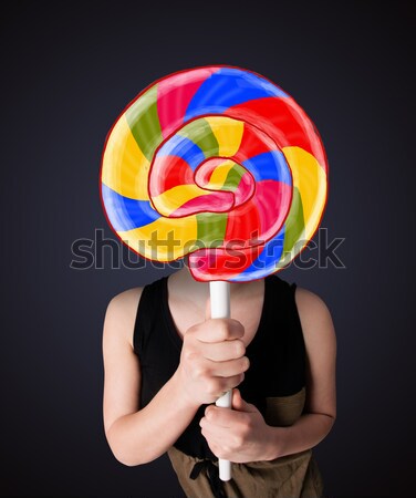 Stock photo: Businessman holding a lollipop