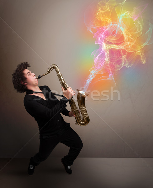 Attractive musician playing on saxophone with colorful abstract  Stock photo © ra2studio