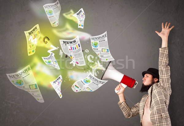 Guy yelling into loudspeaker and newspapers fly out Stock photo © ra2studio