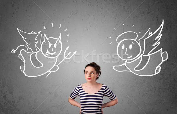 Stock photo: Woman standing between the angel and the devil