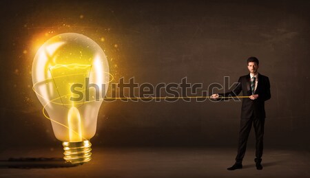 Businessman pulling huge rock with a rope  Stock photo © ra2studio