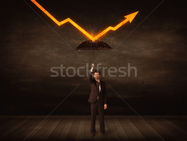 Businessman standing with umbrella keeping orange arrow  Stock photo © ra2studio