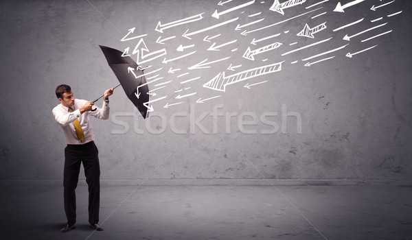 Uomo d'affari piedi ombrello frecce business Foto d'archivio © ra2studio