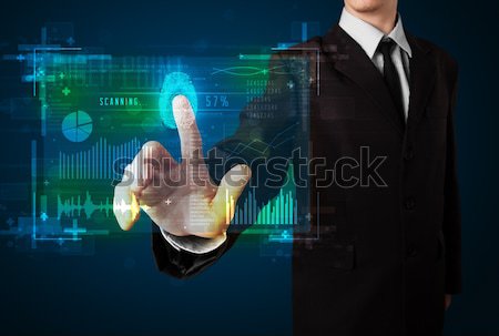 Young businesswoman pressing modern technology panel with finger Stock photo © ra2studio