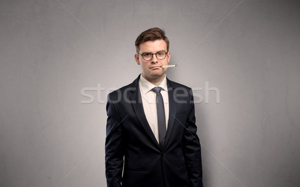 Businessman with thermometer and copy space Stock photo © ra2studio